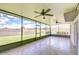 Screened-in patio with tiled floors and ceiling fans, perfect for outdoor entertaining at 208 English Heritage Pl, Dover, FL 33527