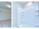 A newly-remodeled, tiled walk-in shower with shelving for toiletries at 208 English Heritage Pl, Dover, FL 33527