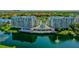 Aerial view of the complex overlooking a pond with a fountain and lush green surroundings at 2333 Feather Sound Dr # B609, Clearwater, FL 33762