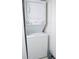 A stacked washer and dryer unit provides laundry convenience in a compact, all-white design at 2333 Feather Sound Dr # B609, Clearwater, FL 33762