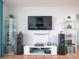 Well-decorated living room features modern entertainment setup and tiled flooring at 2333 Feather Sound Dr # B609, Clearwater, FL 33762