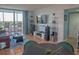 Open concept living space with tile floors, dining area, balcony, media center and comfortable seating at 2333 Feather Sound Dr # B609, Clearwater, FL 33762
