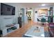 Stylish living room featuring modern furnishings, tile flooring, and an open kitchen view at 2333 Feather Sound Dr # B609, Clearwater, FL 33762