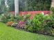 Beautiful backyard garden featuring colorful flowers, lush plants, green grass, and decorative ornaments at 243 Snell Isle Ne Blvd, St Petersburg, FL 33704