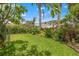 Lush backyard with green lawn, mature trees, and a charming garden area perfect for outdoor enjoyment at 243 Snell Isle Ne Blvd, St Petersburg, FL 33704