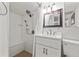 Bathroom featuring updated shower with built-in bench, a sink with modern fixtures, and a framed mirror at 243 Snell Isle Ne Blvd, St Petersburg, FL 33704
