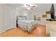 Comfortable bedroom with light-colored wood floors, ceiling fan, shuttered window, and closet with traditional door at 243 Snell Isle Ne Blvd, St Petersburg, FL 33704