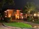 Charming two-story home at night with manicured lawn and inviting front garden at 243 Snell Isle Ne Blvd, St Petersburg, FL 33704