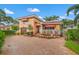 Charming two-story home featuring a beautiful tile roof, red awnings, and a brick-paved driveway at 243 Snell Isle Ne Blvd, St Petersburg, FL 33704