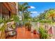 Inviting front porch with potted plants and red-tiled floor at 243 Snell Isle Ne Blvd, St Petersburg, FL 33704