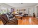 Bright living room showcasing a leather sofa, hardwood floors, and natural light at 243 Snell Isle Ne Blvd, St Petersburg, FL 33704