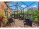 Charming screened patio with brick flooring, comfortable seating, and lush greenery, perfect for outdoor relaxation at 243 Snell Isle Ne Blvd, St Petersburg, FL 33704