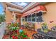 Charming front porch with colorful flowers, awnings, and a red-tiled floor at 243 Snell Isle Ne Blvd, St Petersburg, FL 33704