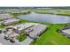 Aerial view of homes with well-maintained lawns and a scenic pond in a Primary-planned community at 271 Monet Trl, Bradenton, FL 34212