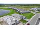 Aerial view showcasing homes in a suburban community, featuring manicured lawns and a serene lake at 271 Monet Trl, Bradenton, FL 34212