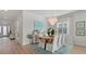 Elegant dining room featuring a modern chandelier, stylish decor, and view into the foyer at 271 Monet Trl, Bradenton, FL 34212