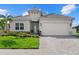 Charming home with a well-manicured lawn, light-colored siding, and a two-car garage at 271 Monet Trl, Bradenton, FL 34212