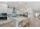 Bright kitchen with white cabinets, quartz countertops, large island and stainless steel appliances at 271 Monet Trl, Bradenton, FL 34212