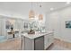 Bright kitchen with white cabinets, quartz countertops and center island at 271 Monet Trl, Bradenton, FL 34212