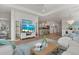 Bright, open-concept living room with modern furnishings, white built-in shelves, and a view into the kitchen at 271 Monet Trl, Bradenton, FL 34212