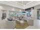 Open-concept living room with modern lighting, wet bar, and plush seating overlooking a pool at 271 Monet Trl, Bradenton, FL 34212