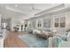 Spacious living and dining area with light wood floors, white walls, and a large chandelier over the dining table at 271 Monet Trl, Bradenton, FL 34212