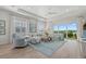 Well-lit living room featuring comfortable seating, stylish decor, and sliding glass doors to an outdoor area at 271 Monet Trl, Bradenton, FL 34212
