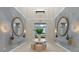 Open-concept entryway features intricate wallpaper, wood-framed mirrors, and neutral furniture at 271 Monet Trl, Bradenton, FL 34212
