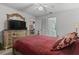 Comfortable bedroom with a large bed, decorative pillows, a dresser with a TV, and neutral tones at 2922 60Th W St, Bradenton, FL 34209