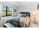 Cozy bedroom with a large window offering natural light, complemented by stylish decor at 2922 60Th W St, Bradenton, FL 34209