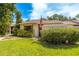 Charming single-story home featuring a well-manicured lawn, mature landscaping, and a quaint picket fence at 2922 60Th W St, Bradenton, FL 34209