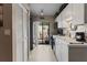 Bright kitchen with white cabinets, black appliances, and a sliding glass door to the outdoor patio at 2922 60Th W St, Bradenton, FL 34209