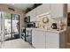 Well-lit kitchen boasts white cabinets, a sleek black oven and microwave, and a sliding glass door to the patio at 2922 60Th W St, Bradenton, FL 34209