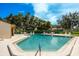 Community pool with ample room for recreation under a sunny sky and surrounding trees at 2922 60Th W St, Bradenton, FL 34209