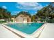 Community pool with ample room for recreation under a sunny sky and surrounding trees at 2922 60Th W St, Bradenton, FL 34209