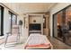 Inviting sunroom with lounge chairs, a daybed, and a TV; perfect for relaxation and entertaining at 2922 60Th W St, Bradenton, FL 34209