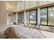 Bright sunroom features neutral decor, large windows, seating and a view to the outdoors at 2922 60Th W St, Bradenton, FL 34209