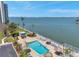 Aerial view of the community pool with lounge seating and beautiful waterfront at 3114 59Th S St # 101, Gulfport, FL 33707