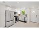 Bright kitchen with stainless steel appliances, white cabinets, and a window view at 3114 59Th S St # 101, Gulfport, FL 33707
