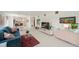 Cozy living room with white floors, blue couch, and access to dining at 3114 59Th S St # 101, Gulfport, FL 33707