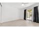 Light-filled bedroom with wood floors, ceiling fan, and sliding glass doors to a patio at 3206 W Azeele St # 120, Tampa, FL 33609