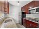 Updated kitchen with stainless steel appliances, granite countertops, and dark wood cabinetry at 3206 W Azeele St # 120, Tampa, FL 33609