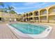 Inviting community pool surrounded by lush landscaping and lounge chairs at 3206 W Azeele St # 120, Tampa, FL 33609