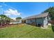 The backyard offers a sparkling pool, green grass, and a covered patio at 3831 Yardley N Ave, St Petersburg, FL 33713