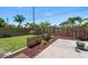 Fenced backyard featuring green grass, mulch beds, and a concrete patio at 3831 Yardley N Ave, St Petersburg, FL 33713