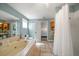 An airy bath includes a shower, tub, and an open doorway to the main bedroom at 3831 Yardley N Ave, St Petersburg, FL 33713