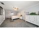 The comfortable carpeted main bedroom features a ceiling fan and white furniture at 3831 Yardley N Ave, St Petersburg, FL 33713