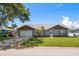 Charming single-story home featuring a well-manicured lawn, mature trees, and an attached two-car garage at 3831 Yardley N Ave, St Petersburg, FL 33713