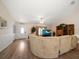 Inviting living room featuring wood flooring, a large sofa, and ample natural light at 3831 Yardley N Ave, St Petersburg, FL 33713