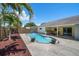 A sparkling pool and a covered patio make for an ideal outdoor living space at 3831 Yardley N Ave, St Petersburg, FL 33713